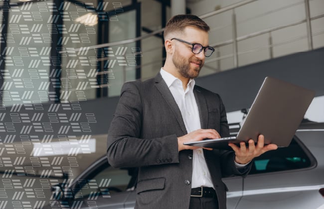 Dealership Manager Reviewing Industry Reports on iPad